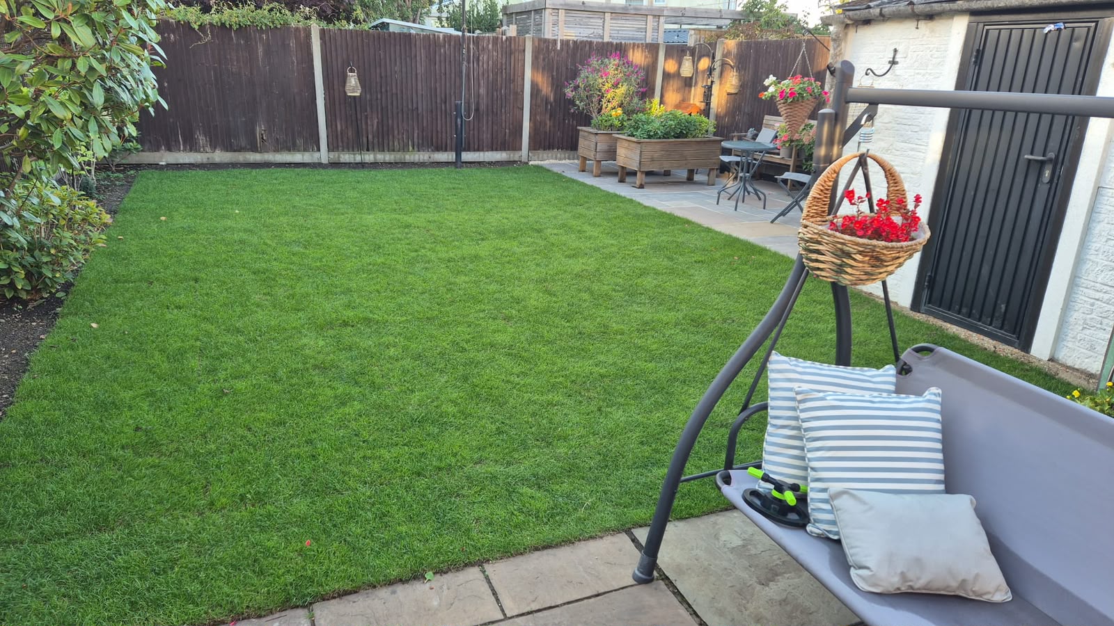 Completed lawn with seating area after turfing work finished