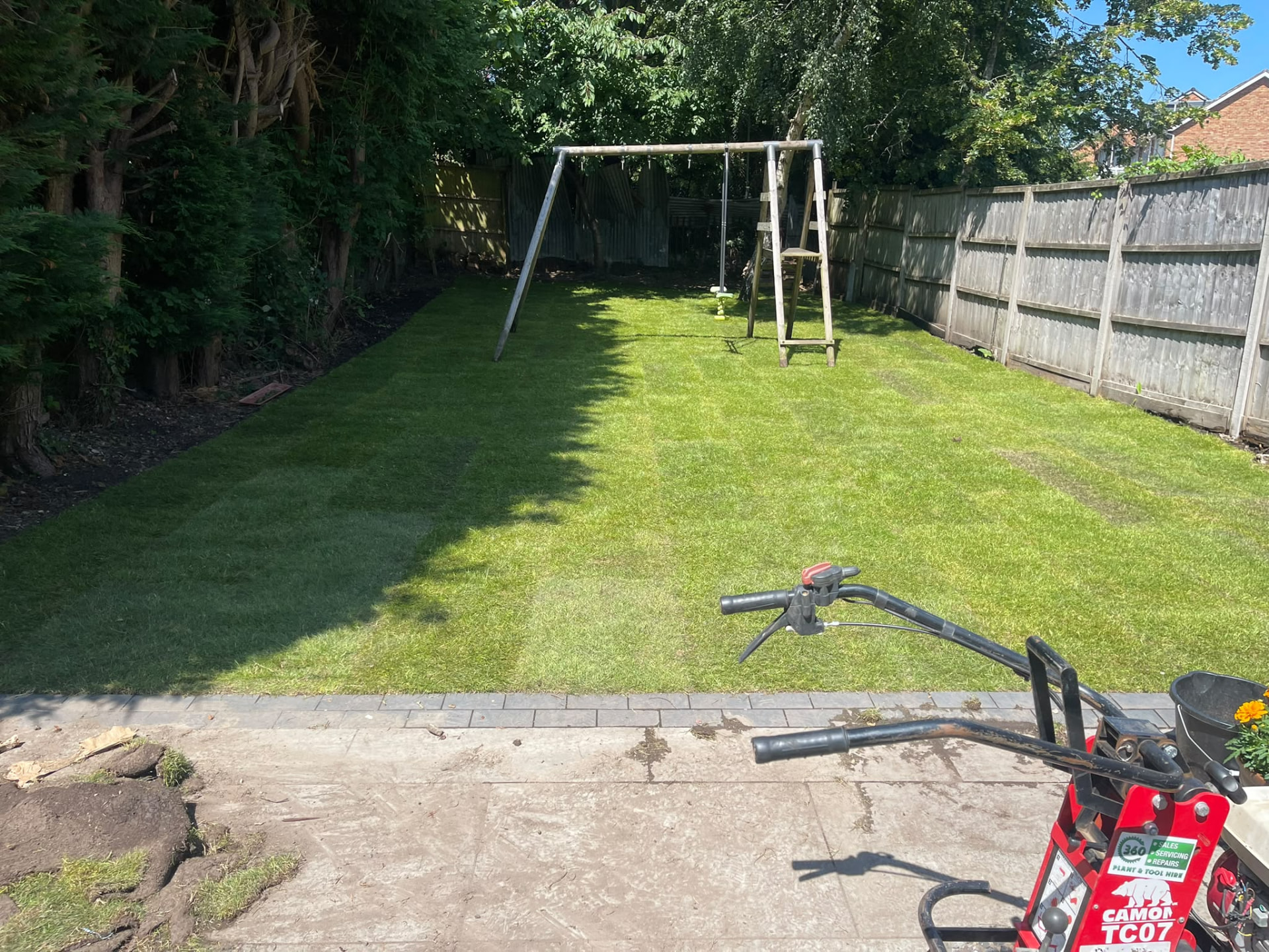 Freshly laid turf completing the new family lawn