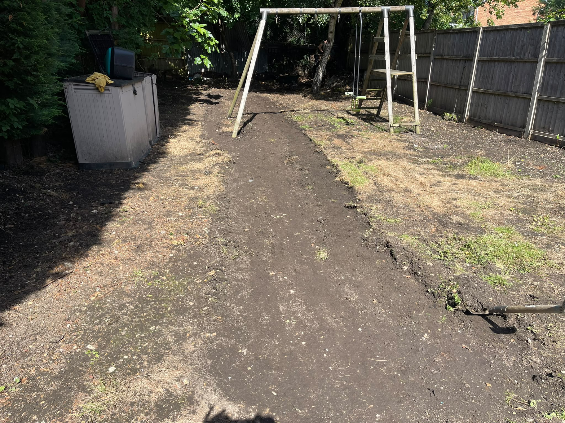 Bare, patchy ground before turfing work began